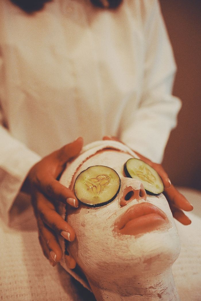 A soothing spa facial treatment with cucumber slices for eye relaxation.