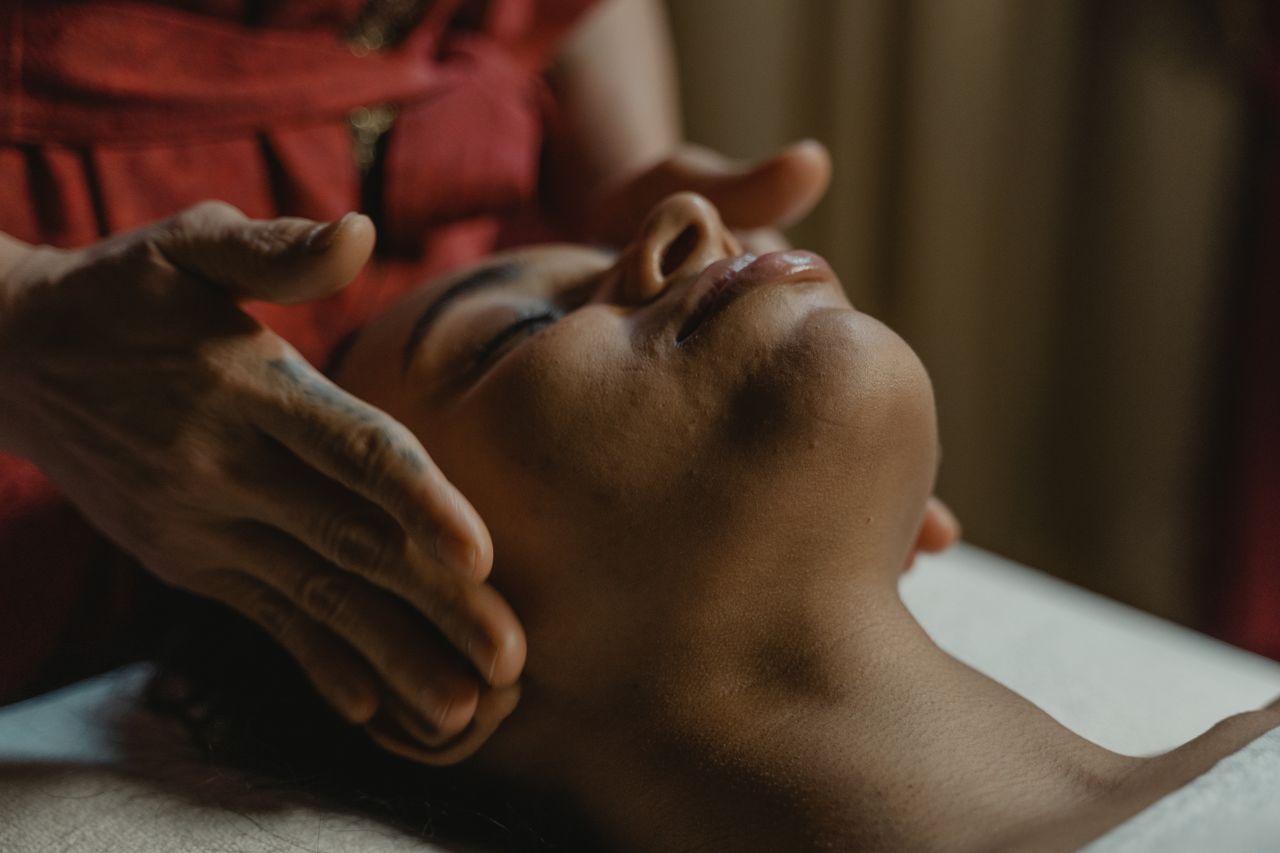 gallery-02 Close-up of a woman receiving a relaxing face massage promoting wellness.